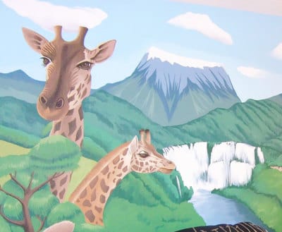 Children's mural of African wildlife with forest and mountains in the background.