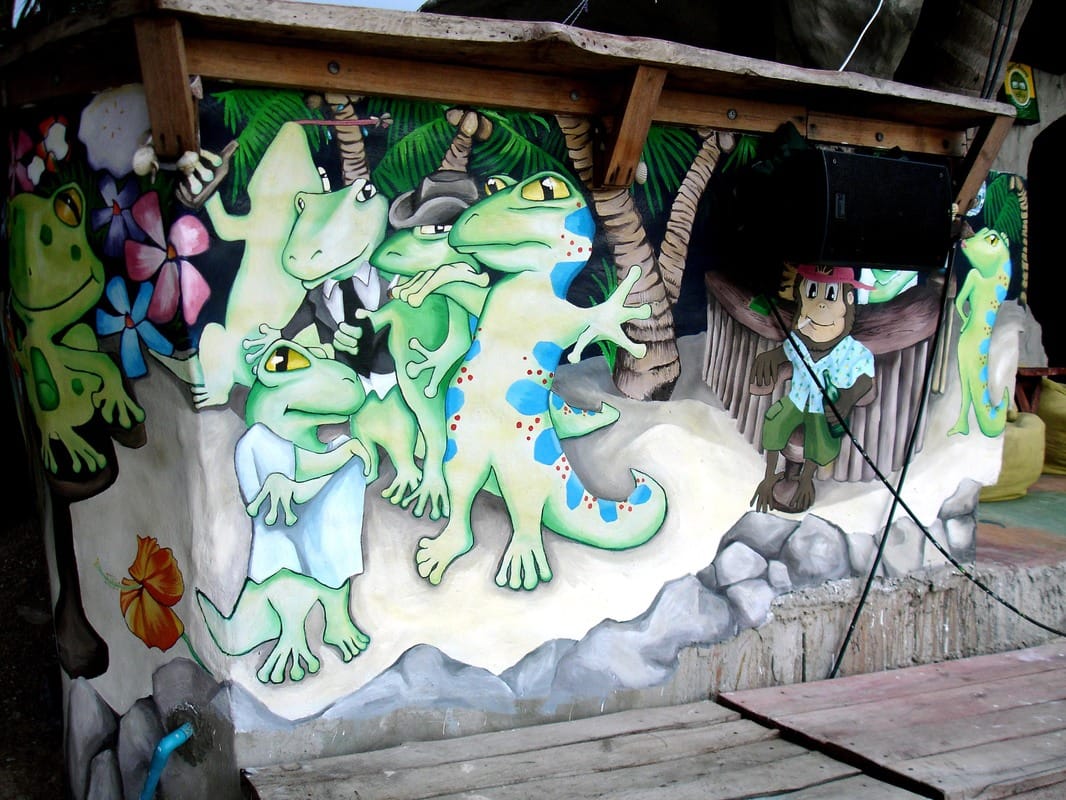 Anime style mural of geckos on tropical beach. 