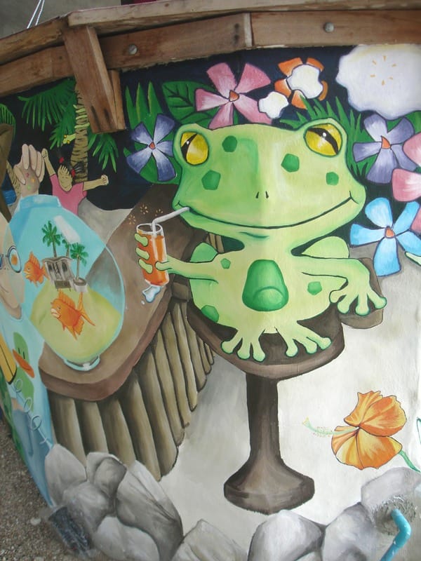 Anime style mural of frog at bar on tropical beach