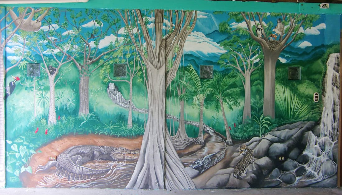 Rainforest mural in Bocas del Toro with jungle animals and birds.