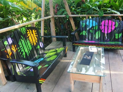 Hand painted upcycled garden furniture benches with tropical flowers in Bocas del Toro.