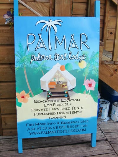 Hand painted sign with tropical beach scene in Bocas del Toro. 