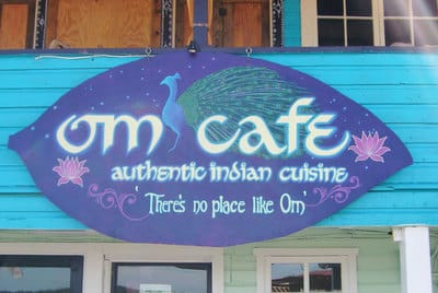 Hand painted Indian cafe sign with peacock and lotus flowers in Bocas del Toro.