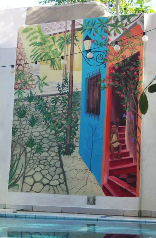 Santo Domingo mural with girl and tropical flowers in street scene. 