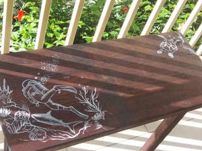 Hand painted upcycled furniture with tropical fish and coral designs in Bocas del Toro. 